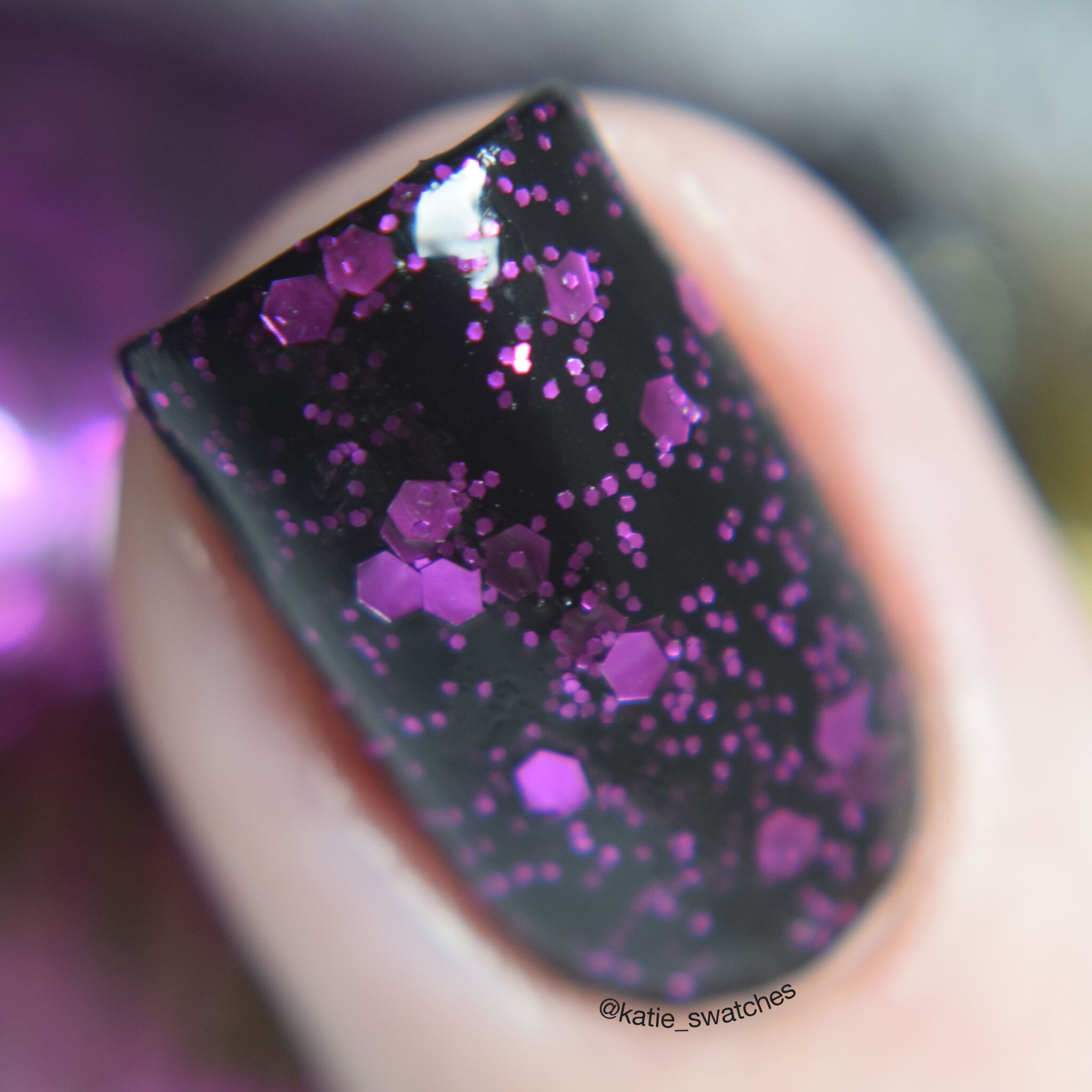 Revlon Facets of Fuchsia 940 nail polish swatch macro - purple glitter with a black base