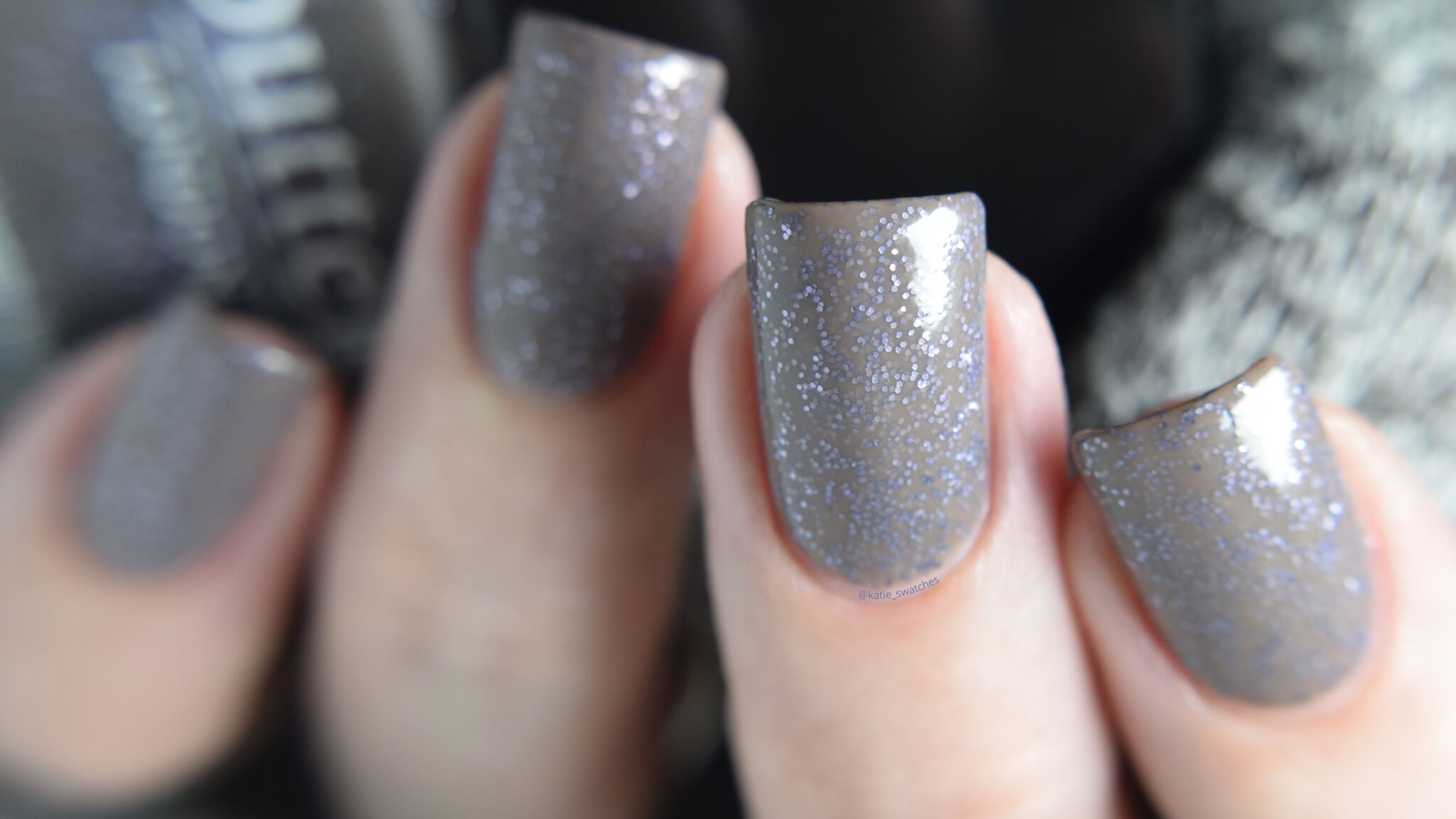 butter LONDON No More Waity, Katie nail polish swatch - taupe grey nail polish with tiny blue glitters