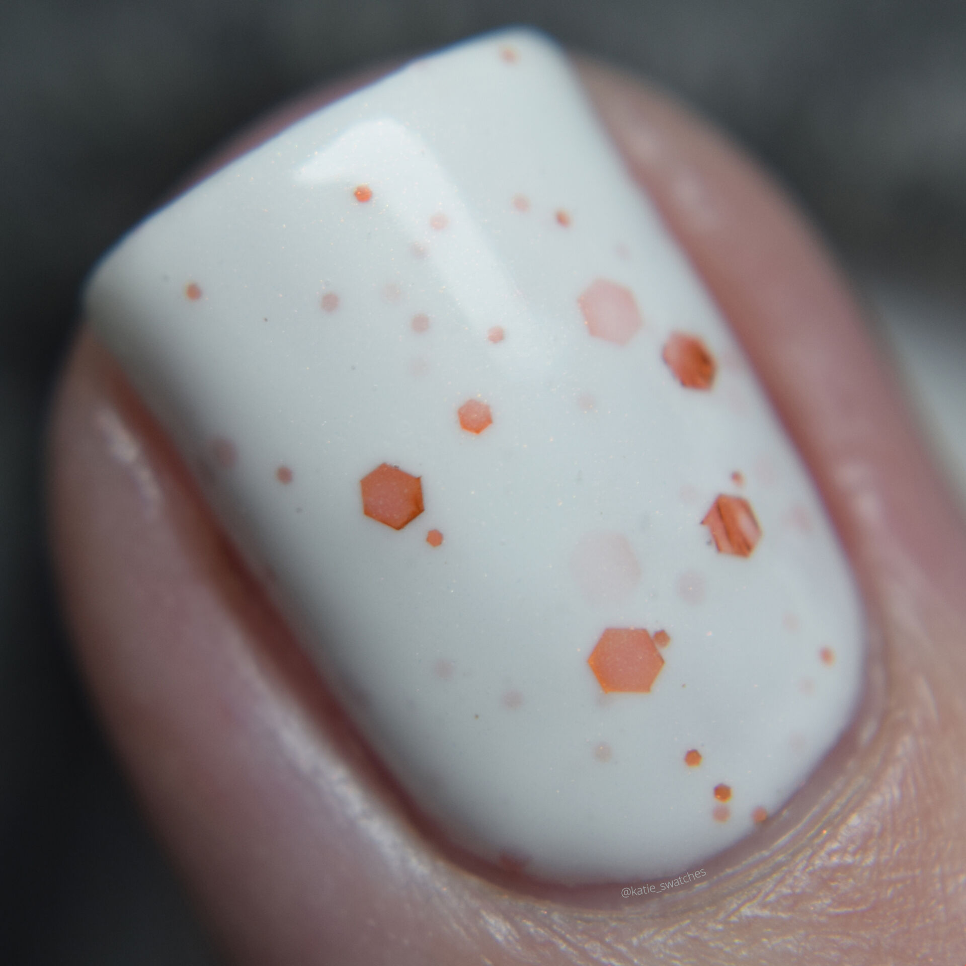 Bedford and Grove - My Eyes! My Eyes! a white crelly nail polish with a slight copper shimmer and orange holo glitters in a variety of sizes. Nail polish swatch macro
