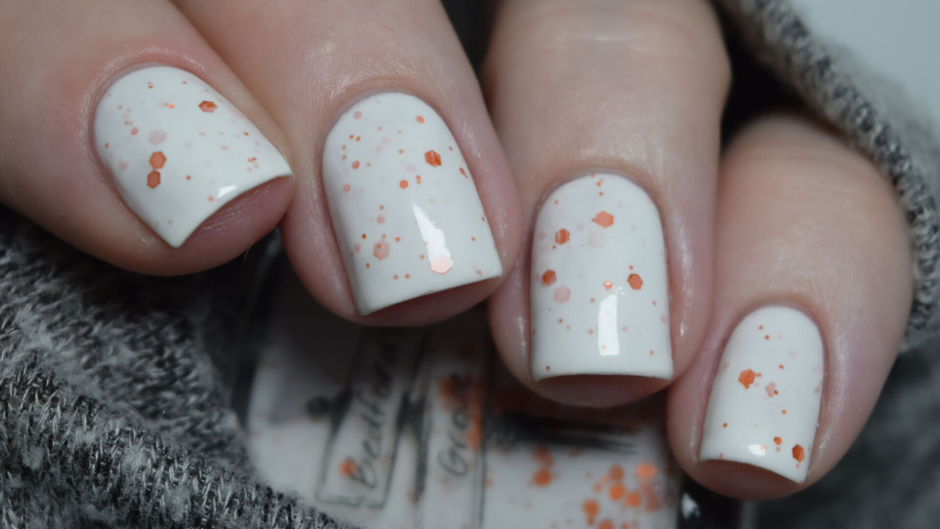 Bedford and Grove - My Eyes! My Eyes! a white crelly nail polish with a slight copper shimmer and orange holo glitters in a variety of sizes. Nail polish swatch