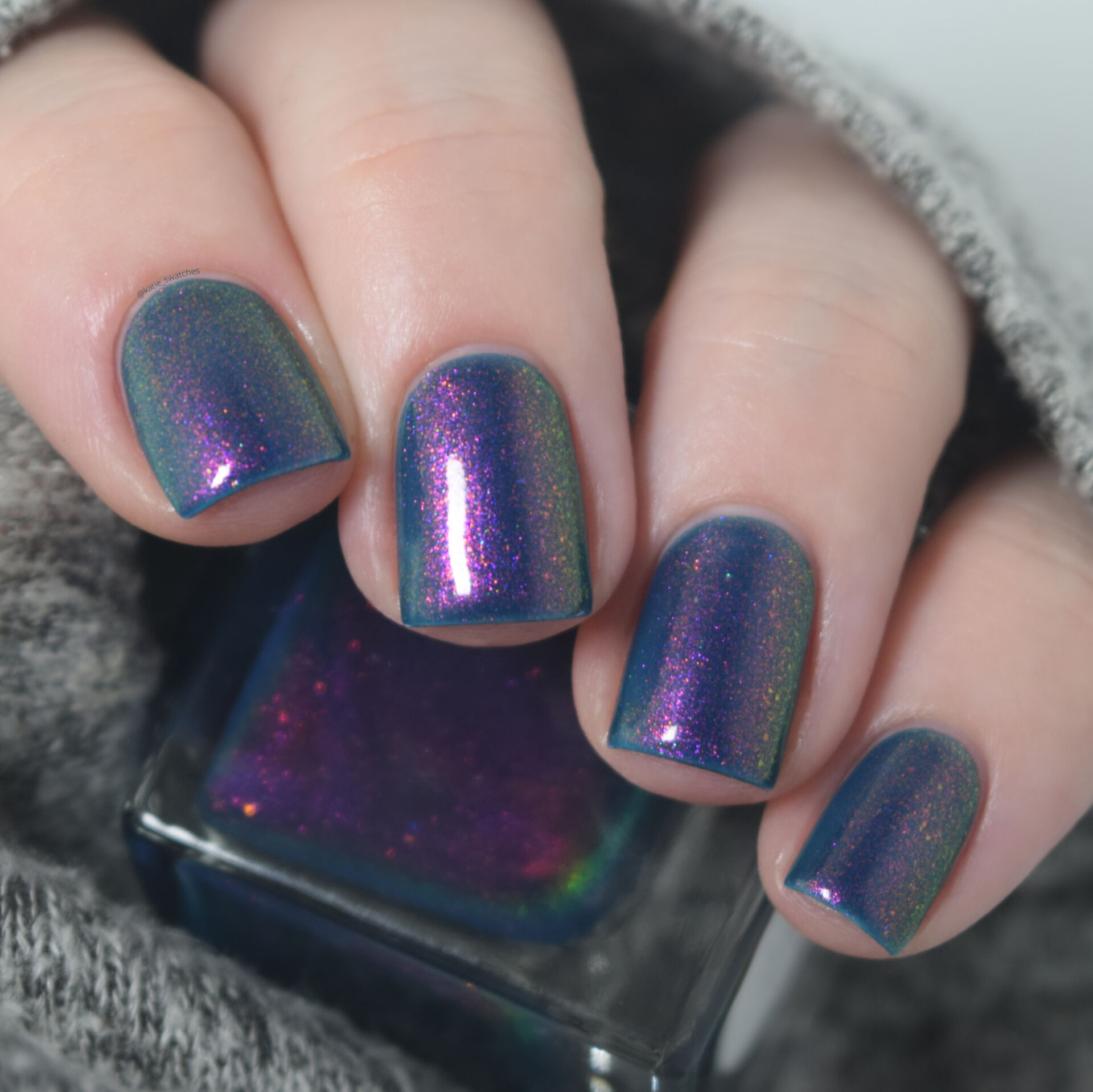 Lemming Lacquer Expanding Consciousness is a deep capri blue jelly packed with red-violet to pink to gold to green shifting shimmer. Nail polish swatch Polish Pickup PPU Exclusive