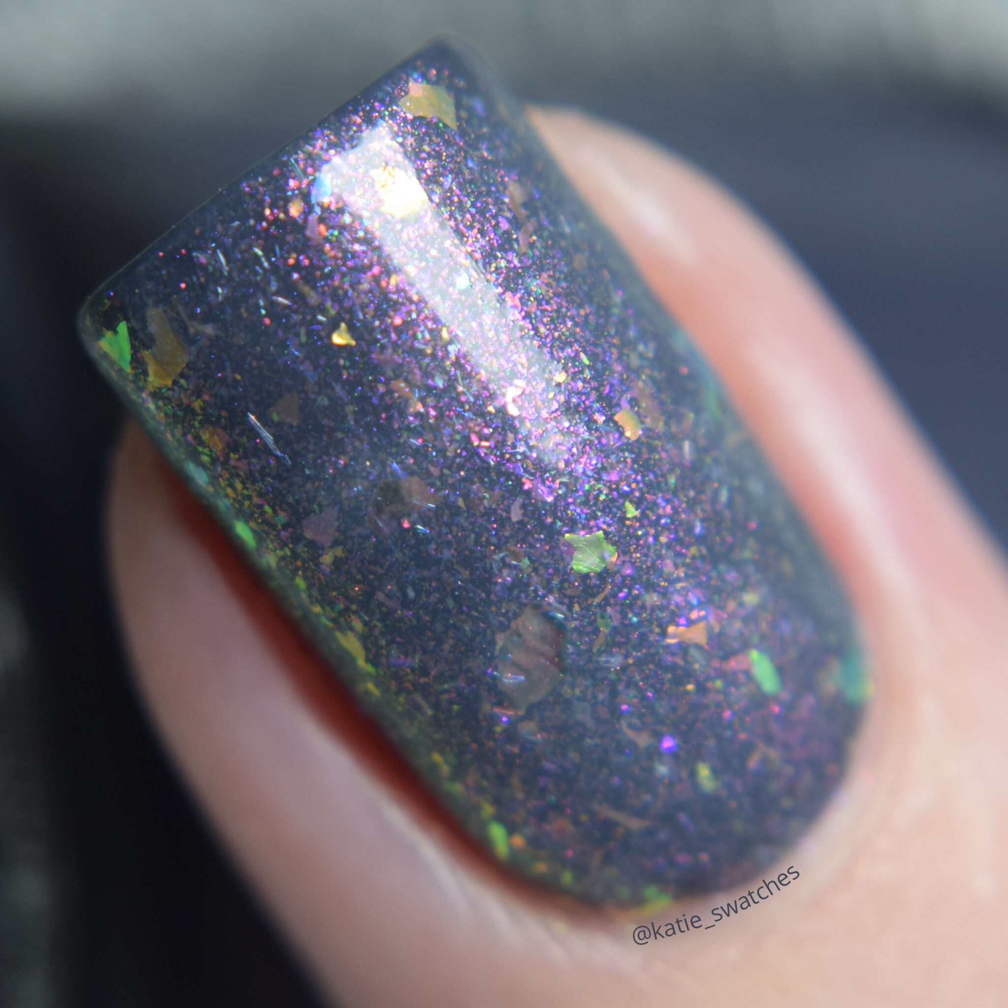 Girly Bits - Thistle While You Work shimmer flakie layered over I'm Pun-decided charcoal creme nail polish swatch macro