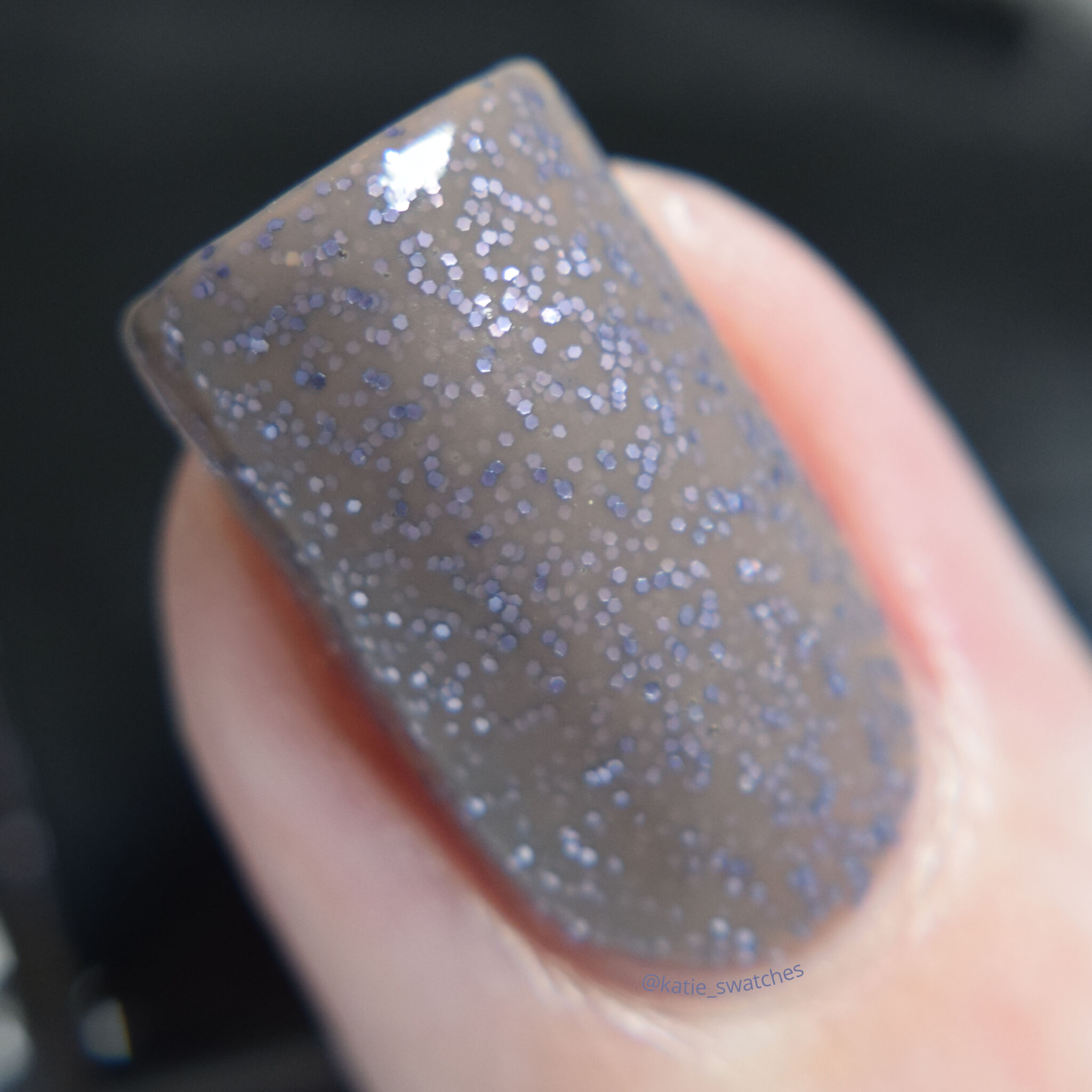 butter LONDON No More Waity, Katie nail polish swatch macro - taupe grey nail polish with tiny blue glitters