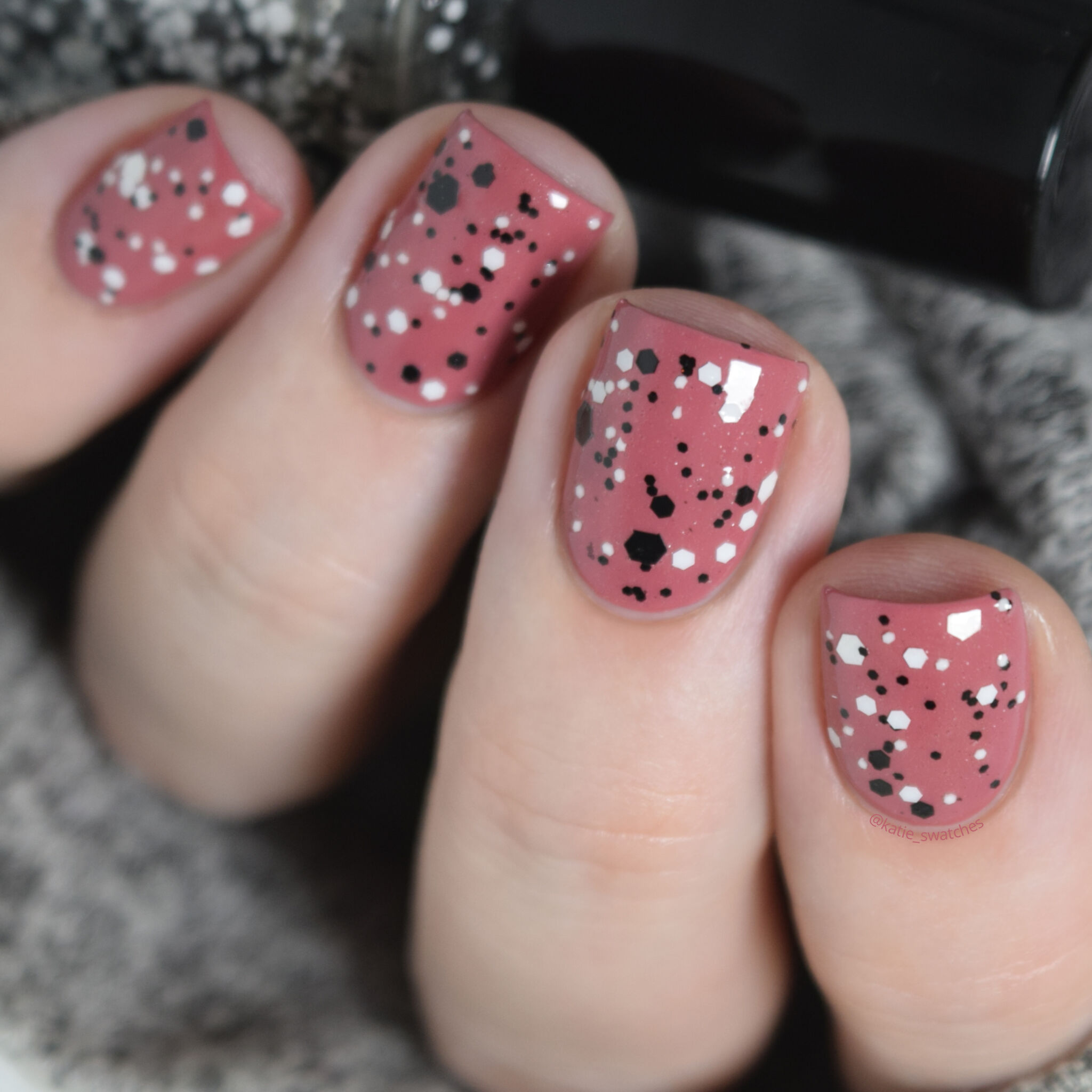 Dollish Polish Putting on the Ritzzz! layered over Sephora Color Hit Rose Bouquet nail polish swatch. Black and white glitter nail polish over a dusty rose creme nail polish.