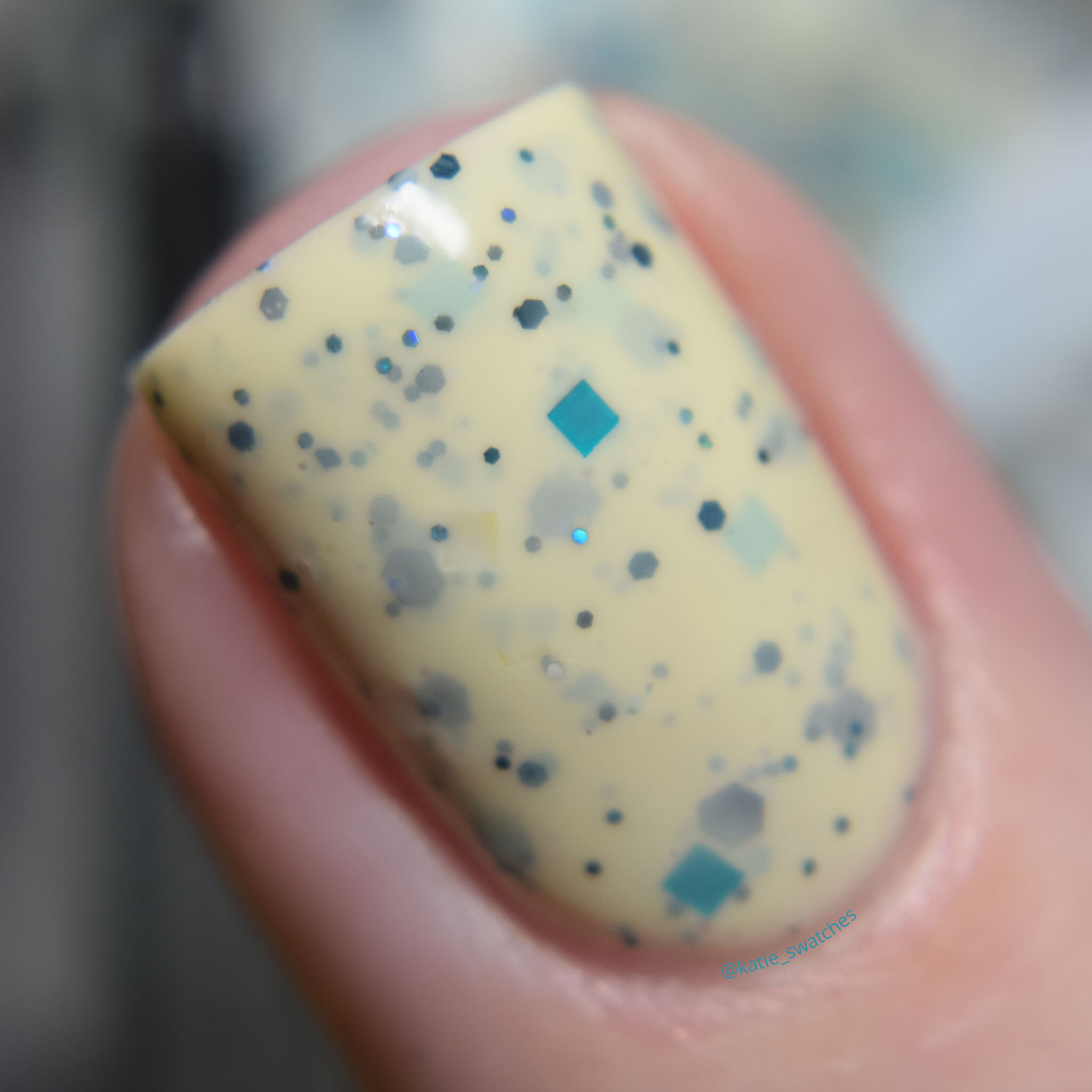 Moon Shine Mani April 2019 Polish Pickup PPU Winged Victory eggshell crelly speckled with a mix of turquoise, black holographic, and various iridescent glitters nail polish swatch macro