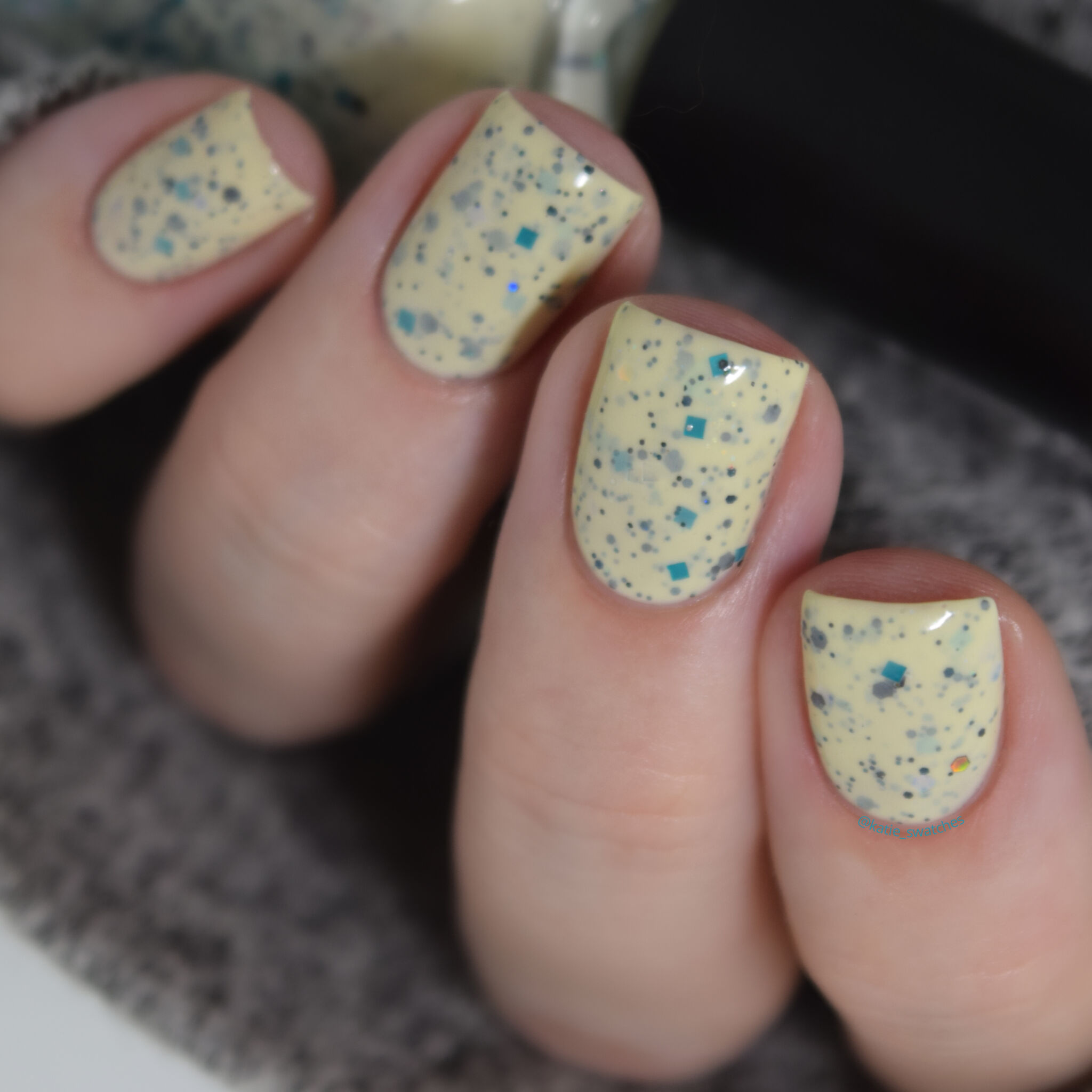 Moon Shine Mani April 2019 Polish Pickup PPU Winged Victory eggshell crelly speckled with a mix of turquoise, black holographic, and various iridescent glitters nail polish swatch