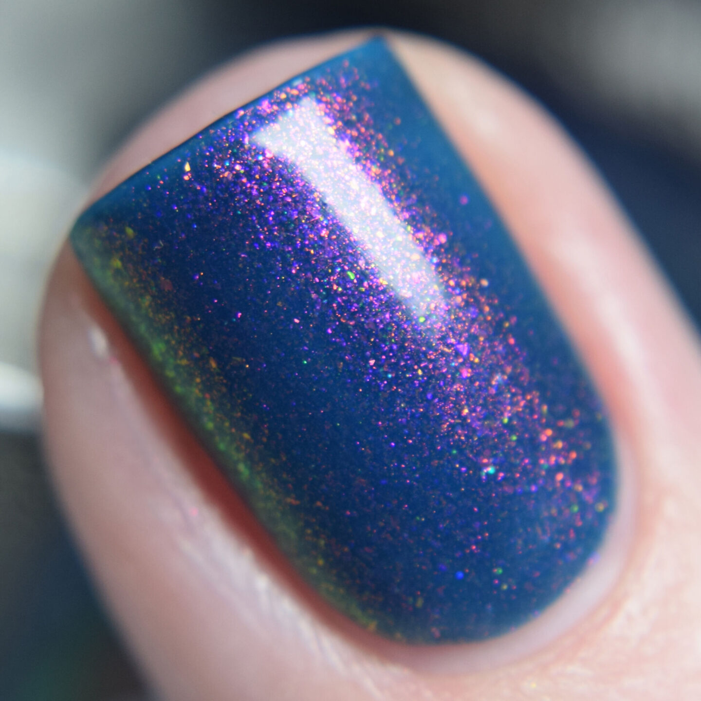 Lemming Lacquer Expanding Consciousness is a deep capri blue jelly packed with red-violet to pink to gold to green shifting shimmer. Nail polish swatch Polish Pickup PPU Exclusive